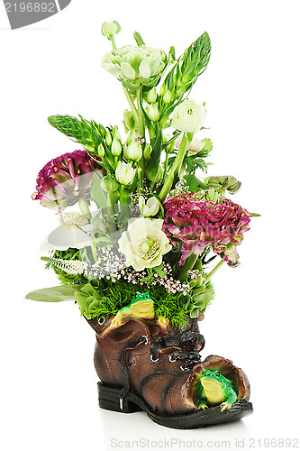 Image of Flower bouquet arrangement centerpiece in old shoe with frogs is