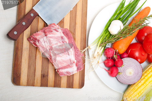 Image of chopping fresh pork ribs and vegetables