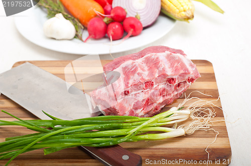 Image of chopping fresh pork ribs and vegetables