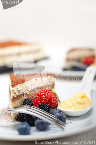 Image of tiramisu dessert with berries and cream