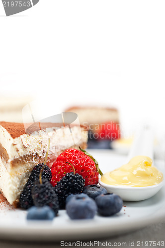 Image of tiramisu dessert with berries and cream