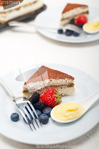 Image of tiramisu dessert with berries and cream