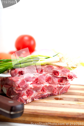 Image of chopping fresh pork ribs and vegetables