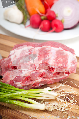 Image of chopping fresh pork ribs and vegetables