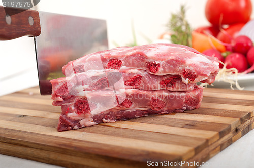 Image of chopping fresh pork ribs and vegetables