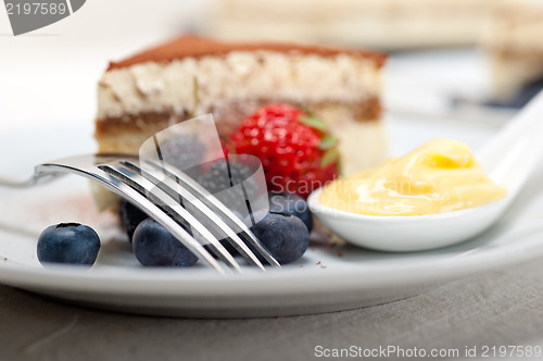 Image of tiramisu dessert with berries and cream