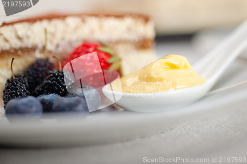 Image of tiramisu dessert with berries and cream