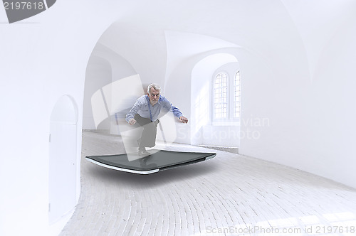 Image of Senior businessman surfing on a tablet