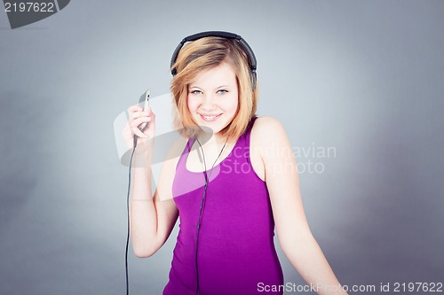 Image of dancing happy teenager girl listening to music 