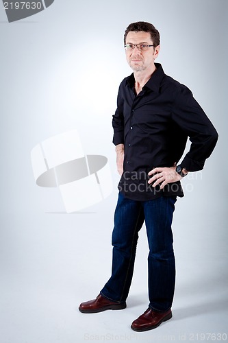 Image of attractive adult man with glasses and black shirt