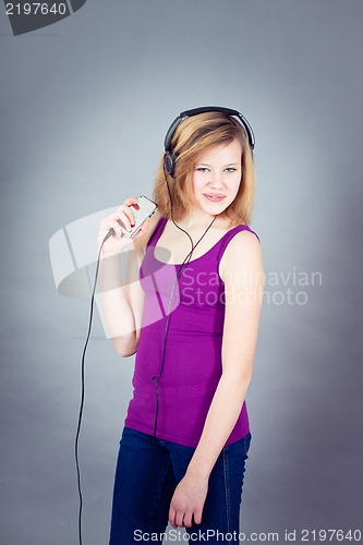 Image of dancing happy teenager girl listening to music 