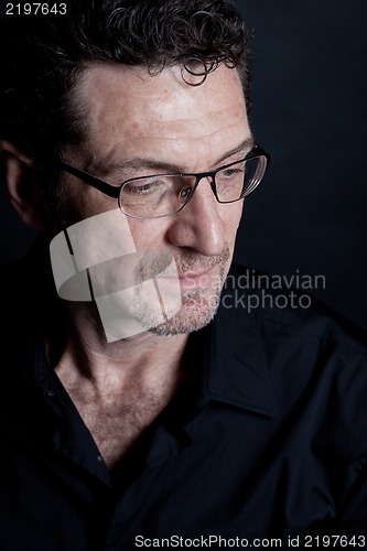 Image of attractive adult man with glasses on black background