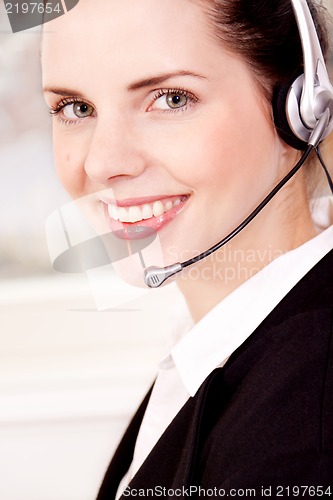 Image of smiling young female callcenter agent with headset