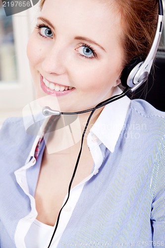 Image of smiling young female callcenter agent with headset