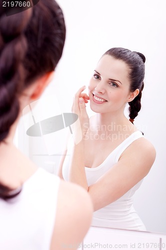 Image of apllying cream on face skincare