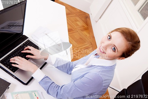 Image of young successful business woman in office