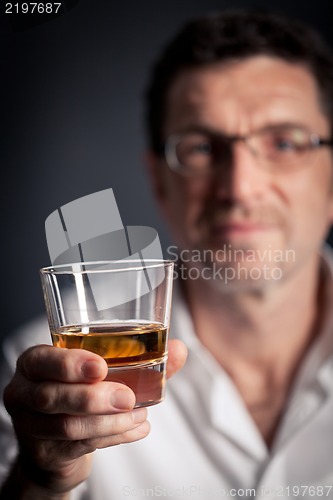 Image of adult man holding an alcoholic drink