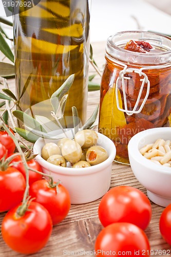 Image of tatsty geen olives tomatoes and olive oil 