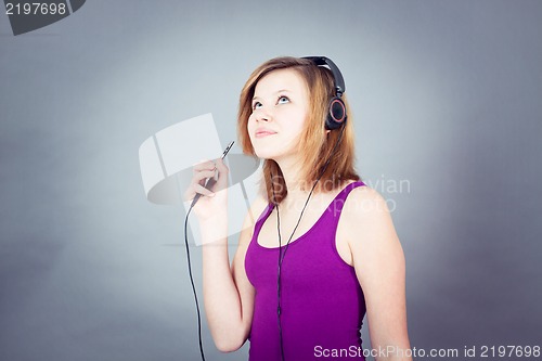 Image of dancing happy teenager girl listening to music 