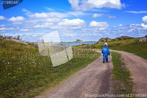 Image of boy walking country road