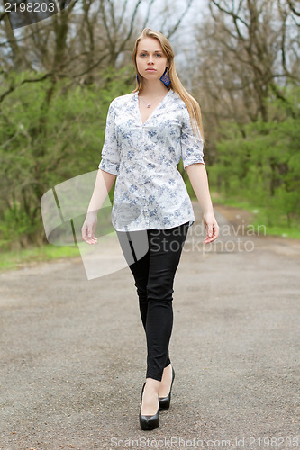 Image of Thoughtful blonde on a footpath