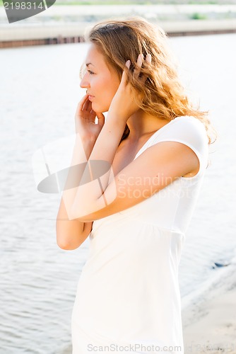 Image of a young brunette caucasian girl at river