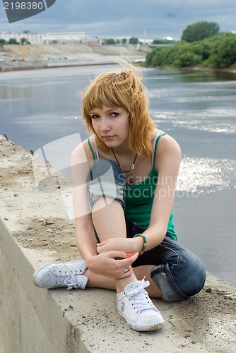 Image of Pretty girl on river bank