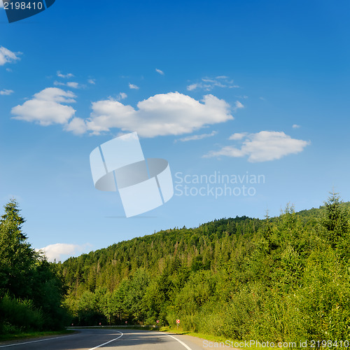 Image of road in mountain under cloudy sky