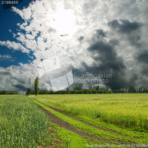 Image of rural road under dramatic sky