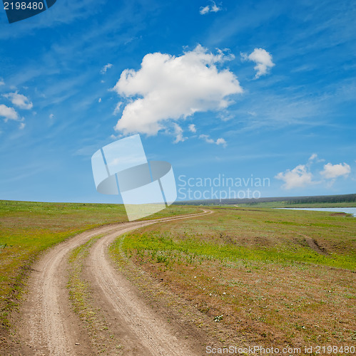 Image of winding rural road to horizon under cloudy sky