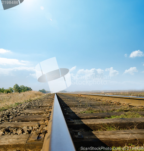 Image of railway to horizon under sunny sky