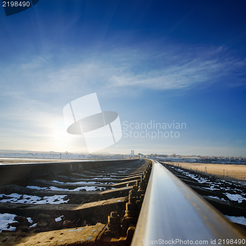 Image of railroad to sunset. winter time