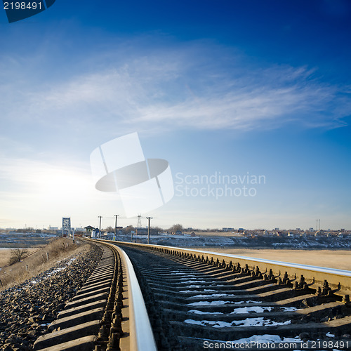 Image of railroad to horizon under deep blue sky in sunset