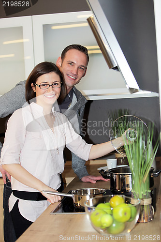 Image of Young couple preparing dinner