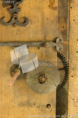 Image of closeup retro wooden clock grunge mechanism gear 