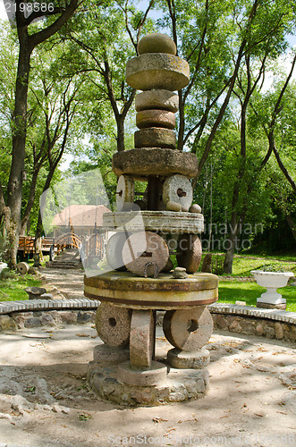 Image of rural park decor figure retro vintage millstones 