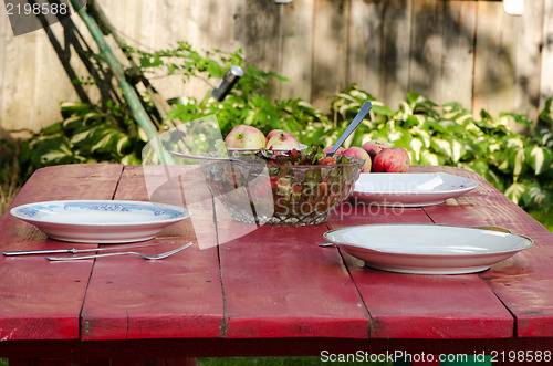 Image of salad glass dish apple wooden house table outdoor 