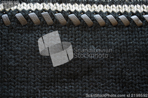 Image of woollen knit sweater leather stitch closeup 