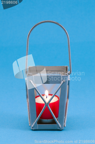Image of retro candlestick handle red candle burn blue 