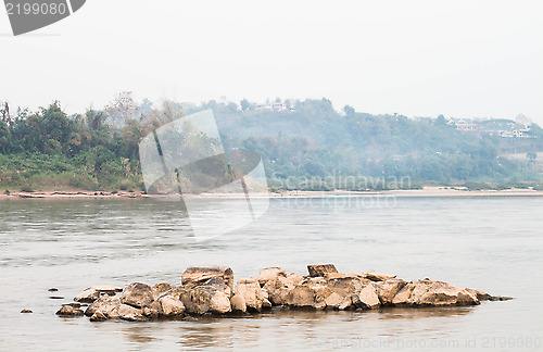 Image of Peaceful scenic view of rocks middle the river