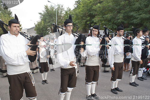 Image of Spanish folk musicians group playing bagpipes