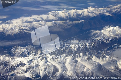 Image of Pattern of snow, clouds and stones