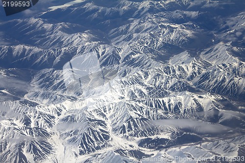 Image of Pattern of snow, clouds and stones: view from height.