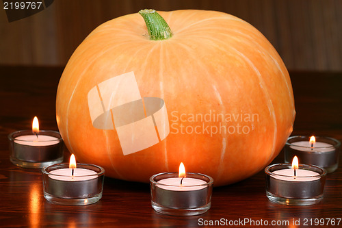 Image of Pumpkin in light of candles