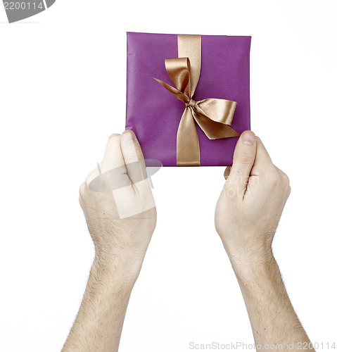 Image of Young man holding a present