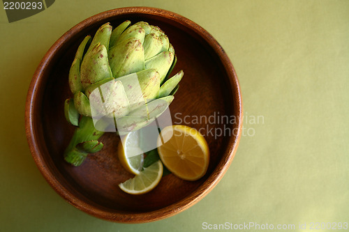 Image of Artichoke in Wooden Bowl With Lemons