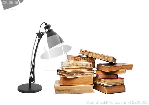 Image of old books with a lamp