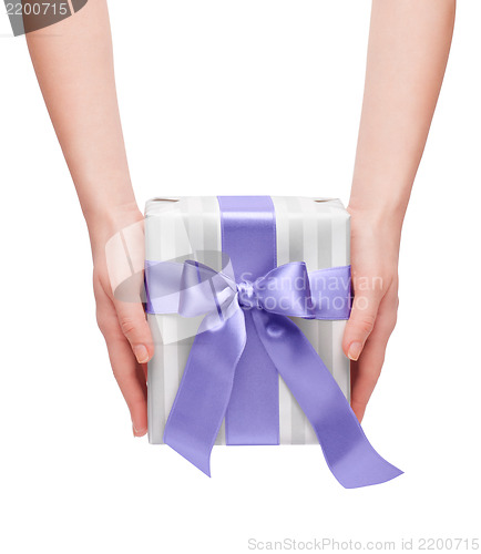 Image of male holding gift box with a bow isolated on white background