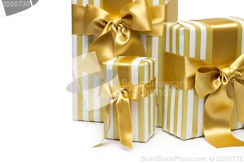 Image of Gold gift boxes isolated on white background