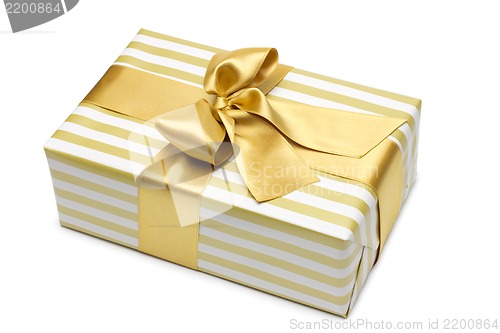 Image of Gift box in gold duo tone with golden satin ribbon and bow isolated over white background.